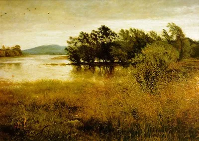 Cold autum lake with trees swaying in the wind